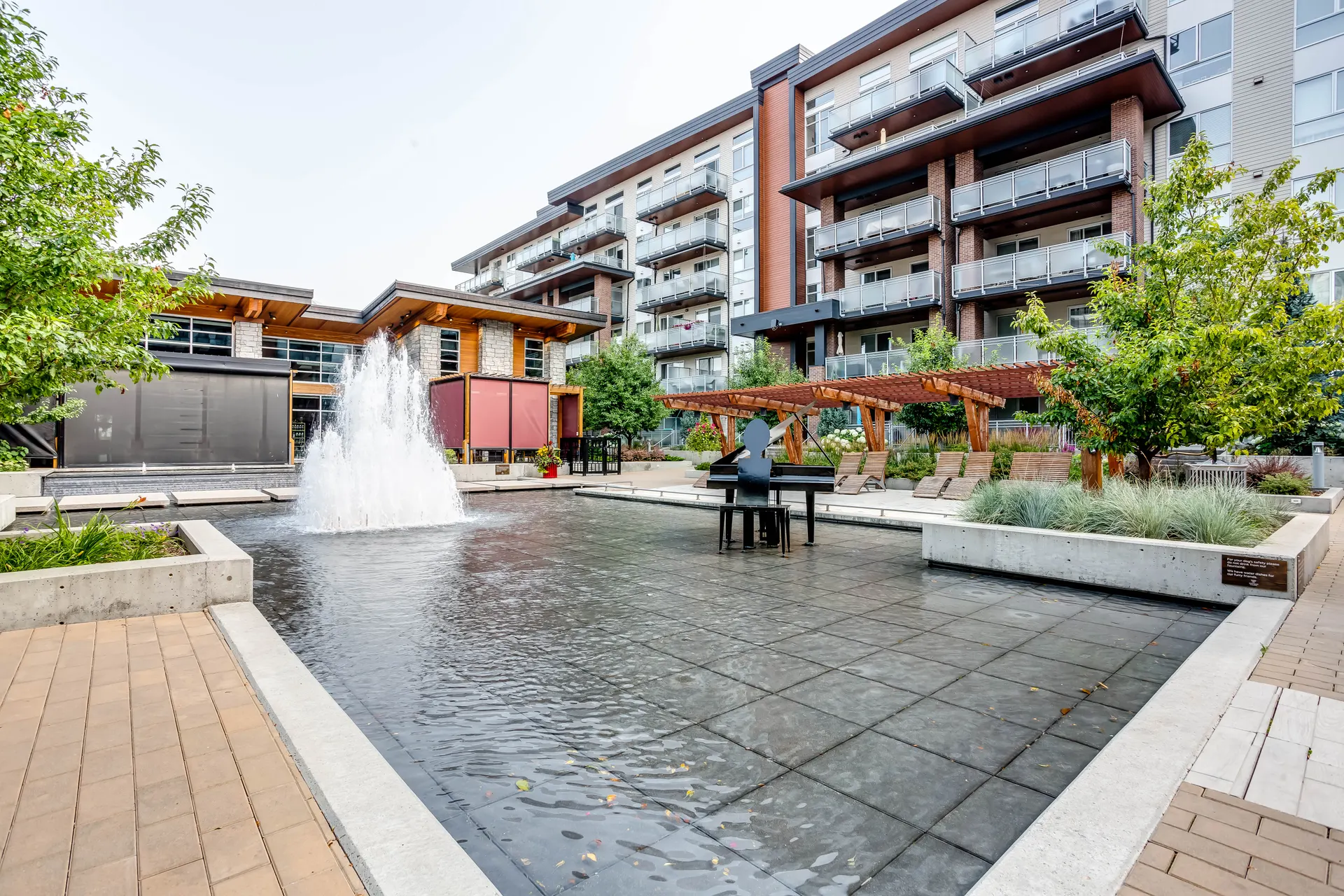 Westman Village fountain plaza, timber pergolas and residential buildings in Mahogany