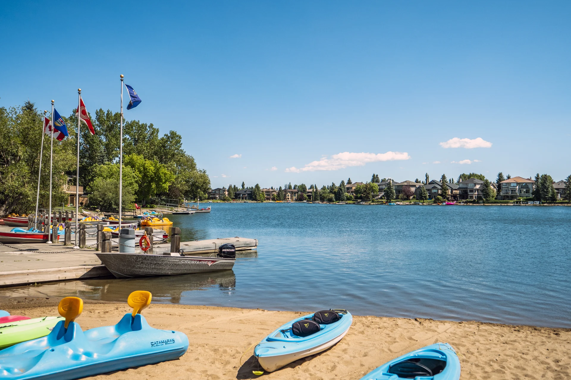Photograph of Sundance lake, beach, kayaks and dock